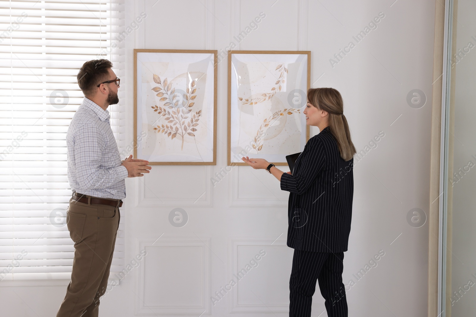 Photo of People viewing exposition in modern art gallery