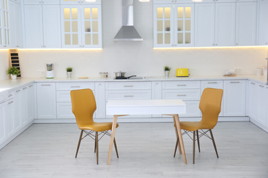 Photo of Beautiful kitchen interior with new stylish furniture