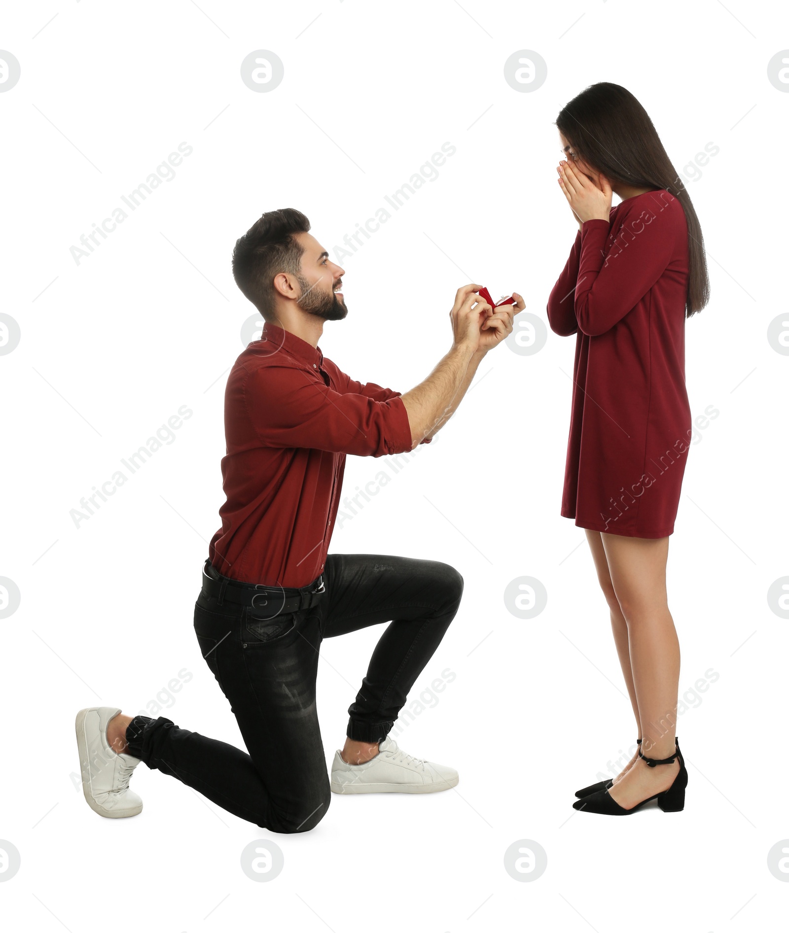 Photo of Man with engagement ring making marriage proposal to girlfriend on white background