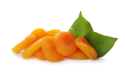 Photo of Pile of tasty apricots and green leaves on white background. Dried fruits