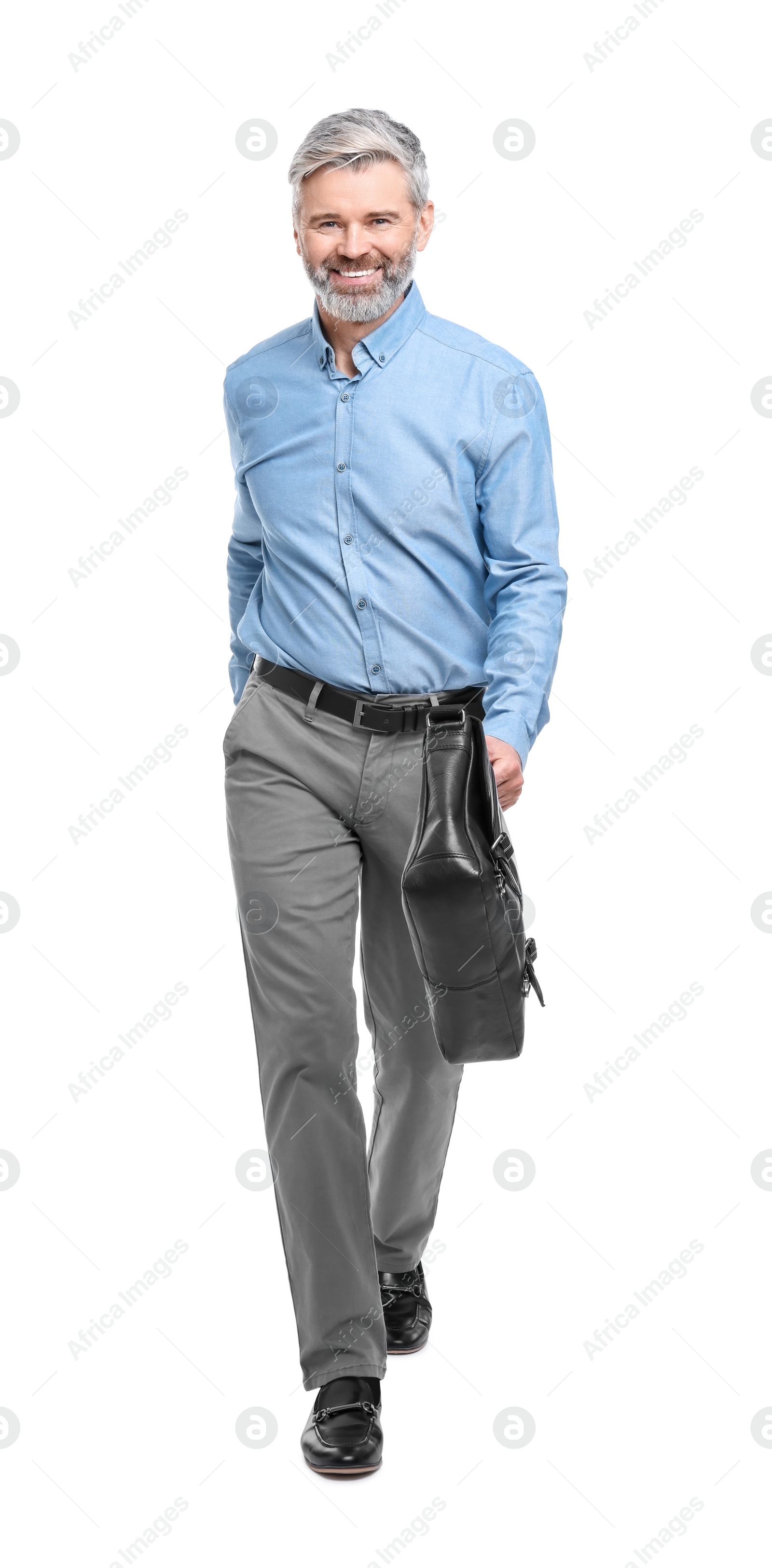 Photo of Mature businessman in stylish clothes with briefcase walking on white background