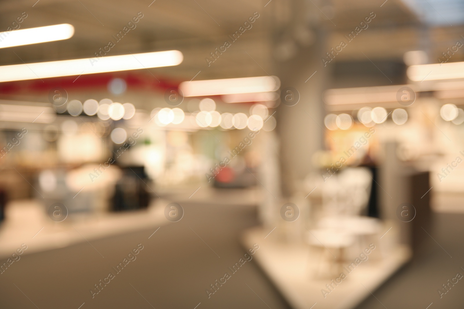 Photo of Blurred view of modern shopping mall interior