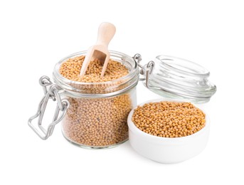 Photo of Aromatic mustard seeds in bowl and glass jar on white background