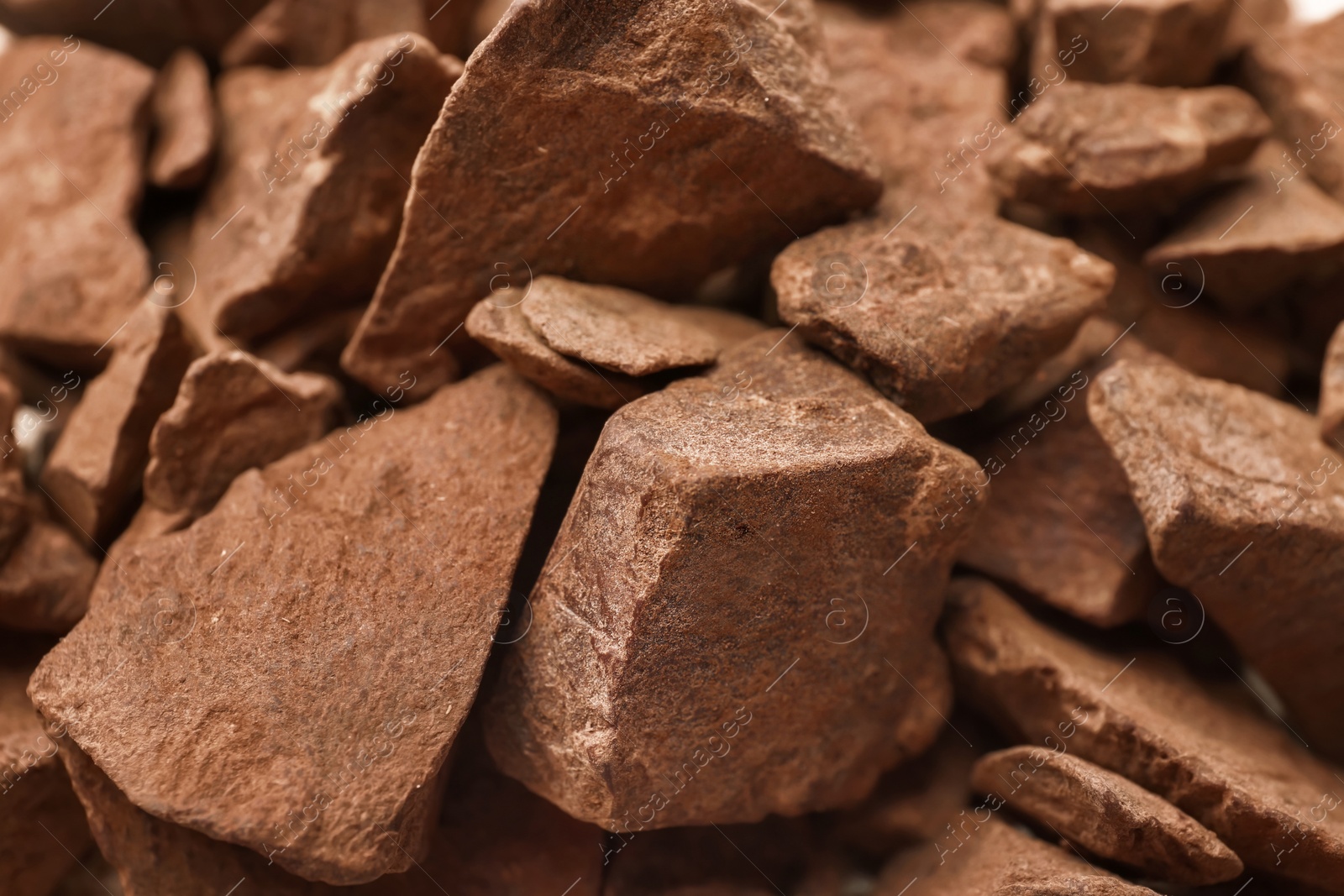 Photo of Delicious black chocolate chunks, closeup