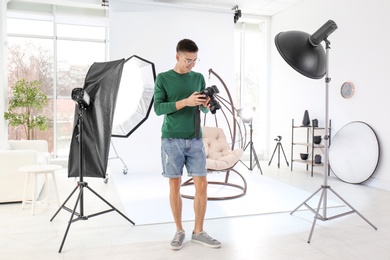 Young photographer working in professional studio