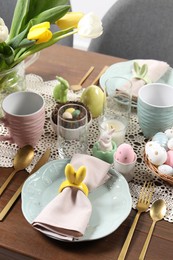 Festive table setting with napkin ring in shape of bunny ears. Easter celebration