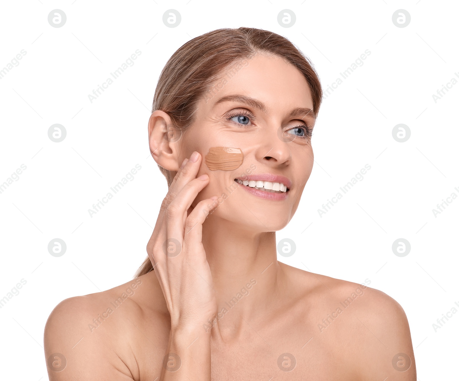 Photo of Woman with swatch of foundation on face against white background