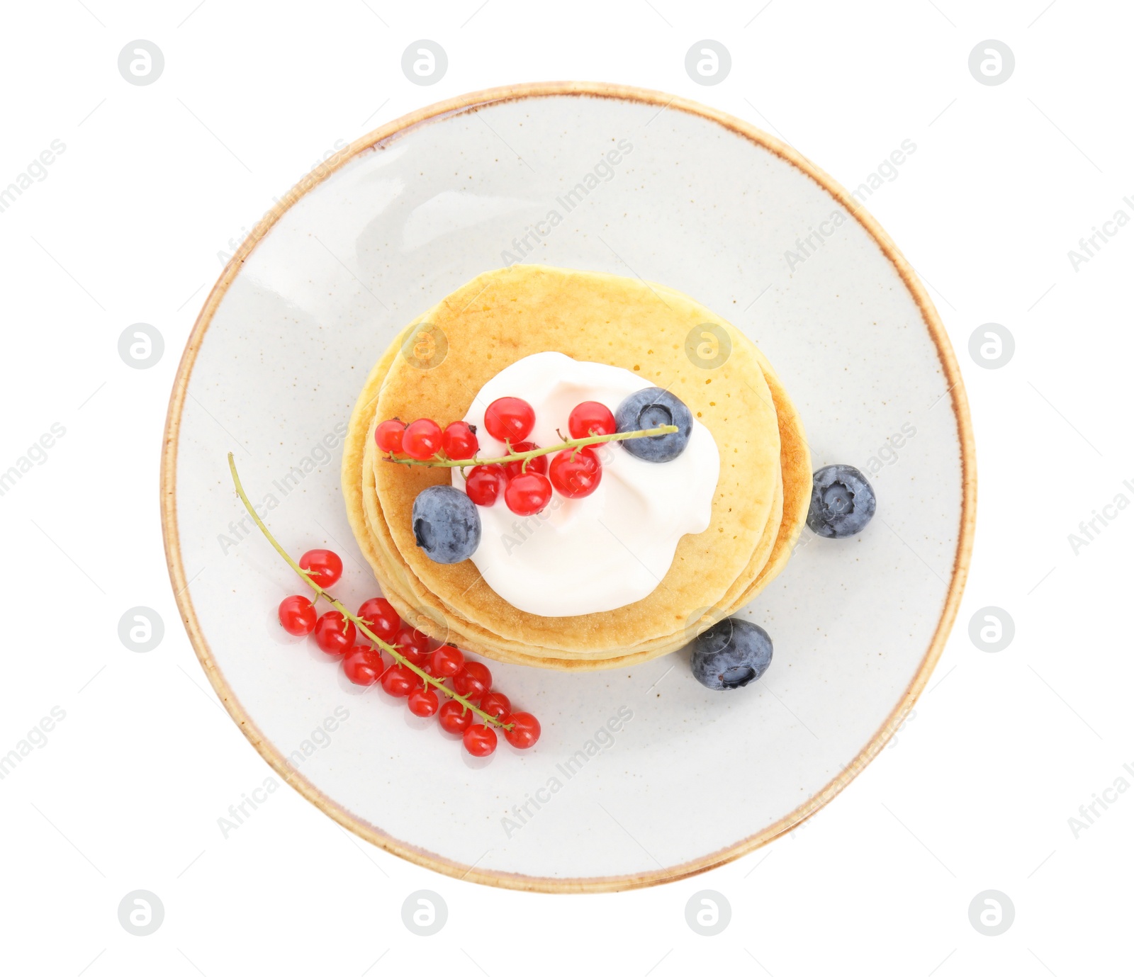 Photo of Tasty pancakes with natural yogurt, blueberries and red currants on white background, top view