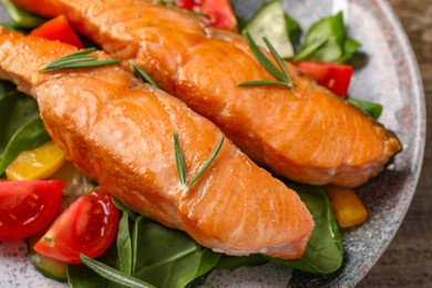 Photo of Healthy meal. Tasty grilled salmon with vegetables and spinach on table, closeup