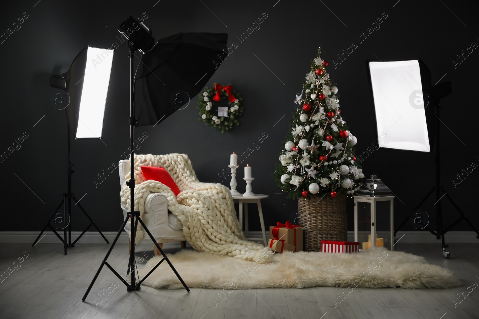 Photo of Beautiful photo zone with professional equipment and  decorated Christmas tree