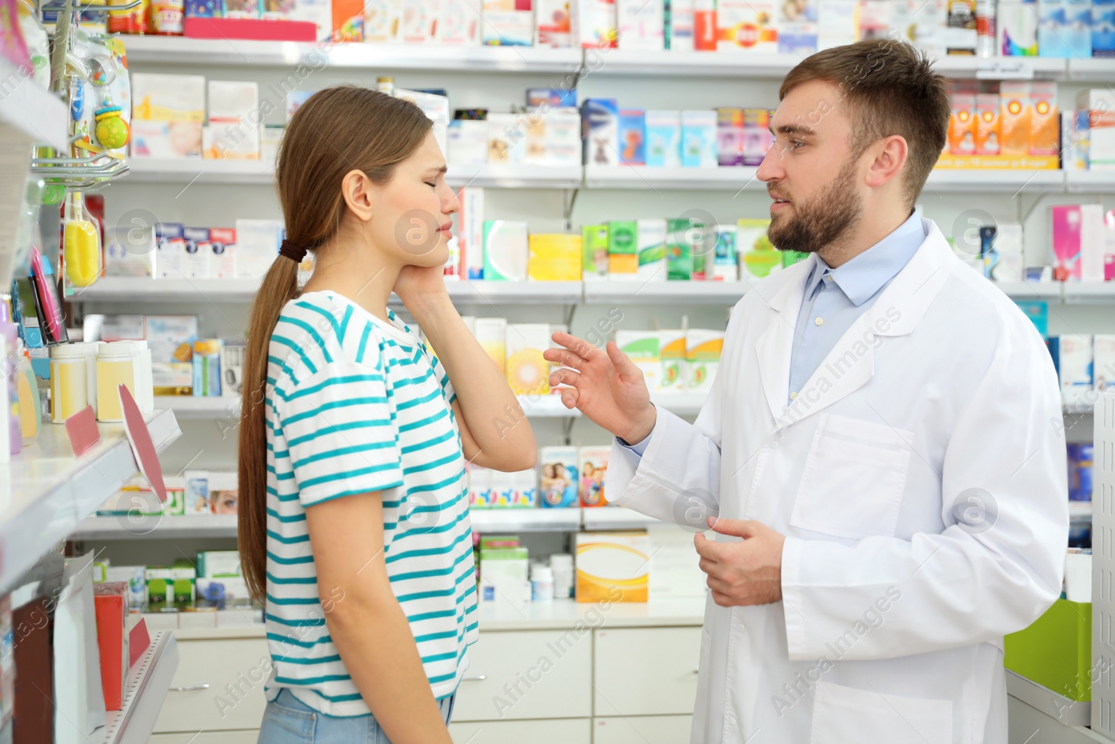 Image of Professional pharmacist working with customer in modern drugstore