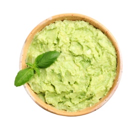 Photo of Bowl of tasty avocado sauce with basil on white background, top view
