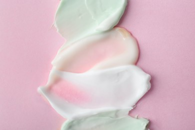 Sample of cream on pink background, top view