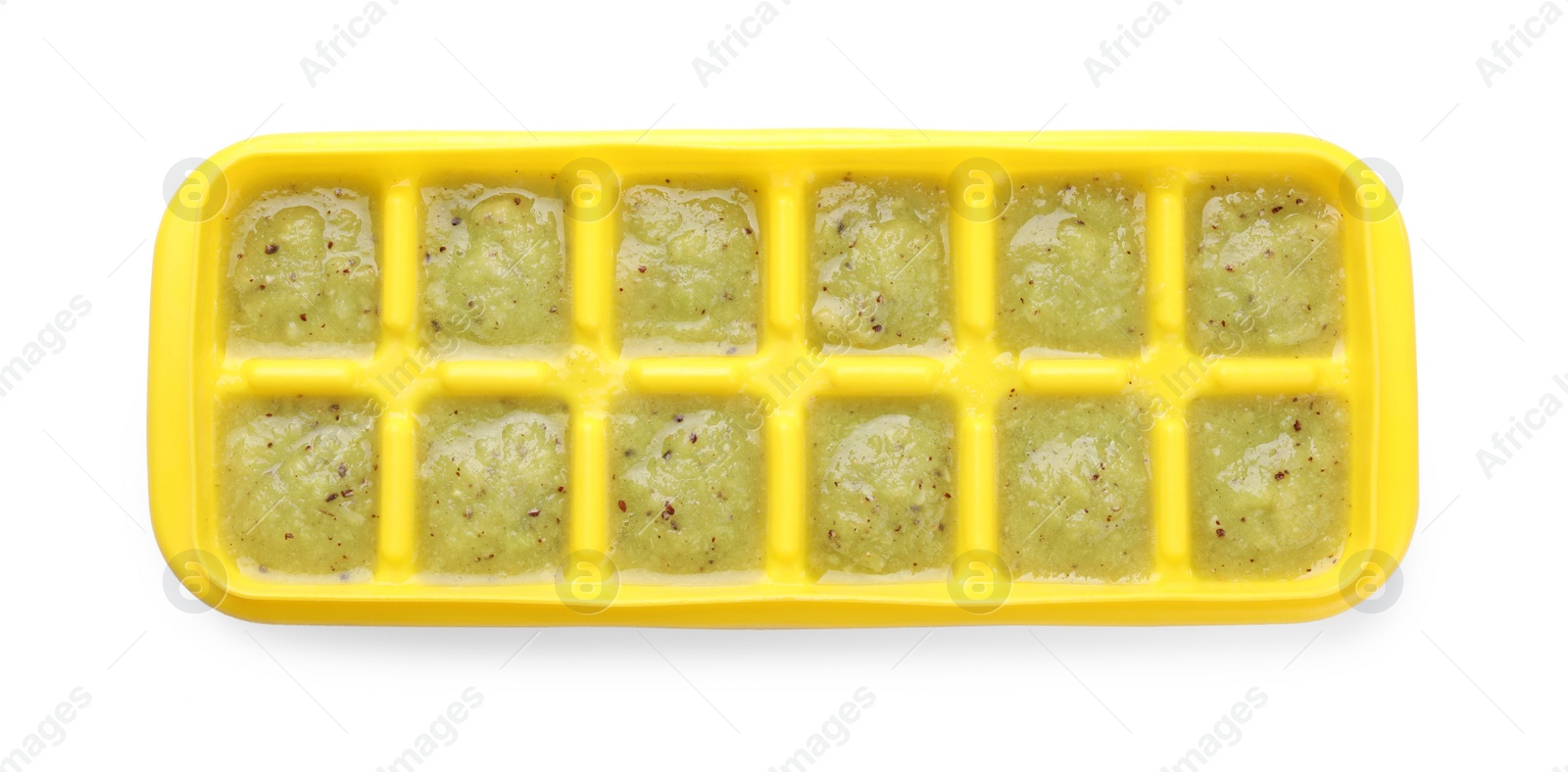 Photo of Kiwi puree in ice cube tray isolated on white, top view. Ready for freezing
