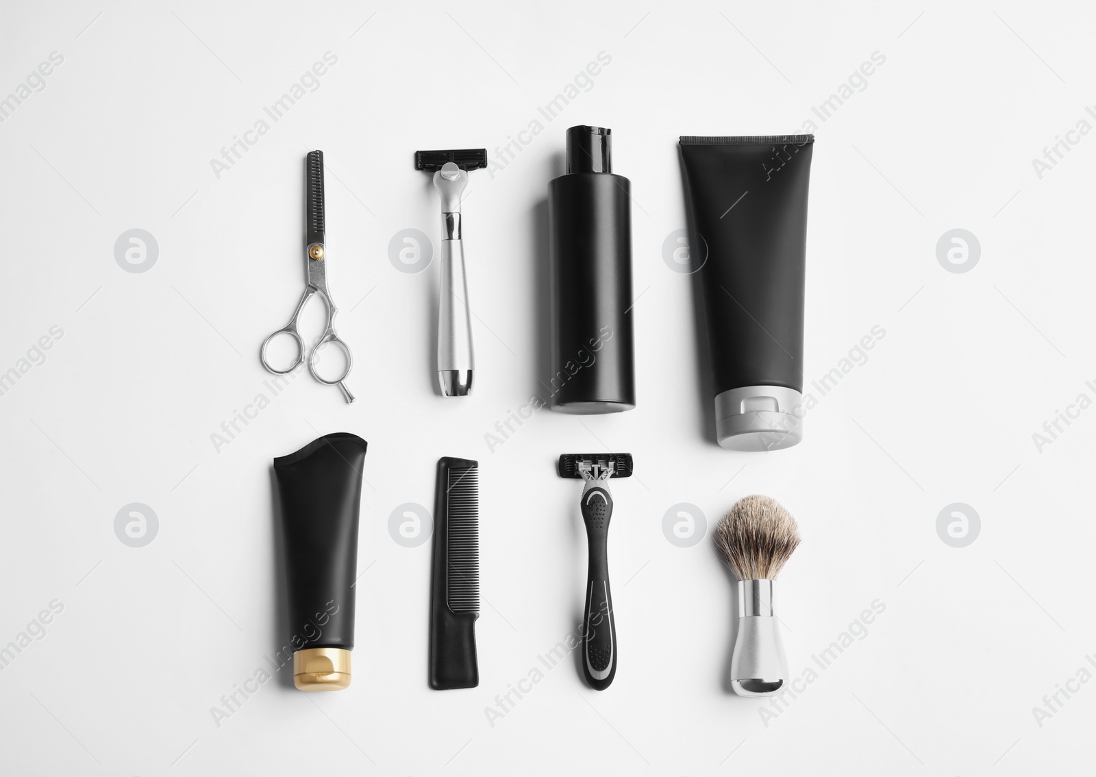 Photo of Set of barber's equipment and men's cosmetic products on light background, top view