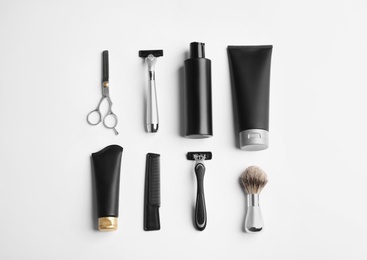 Photo of Set of barber's equipment and men's cosmetic products on light background, top view