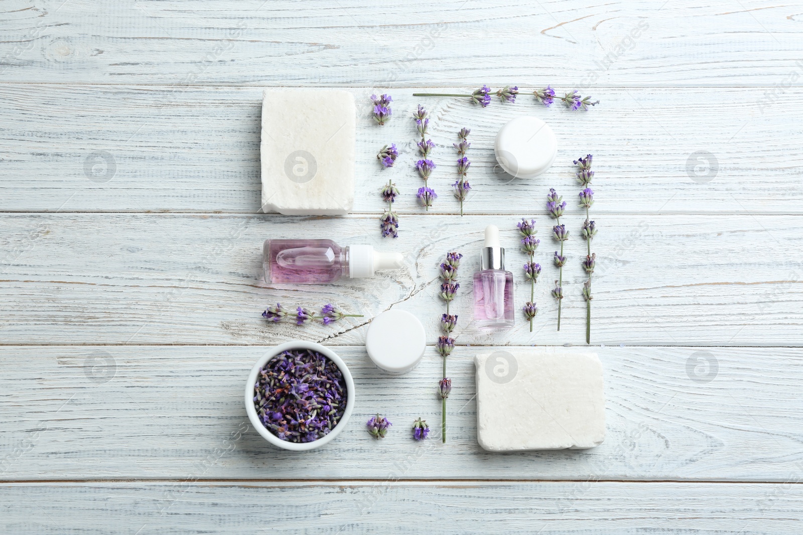 Photo of Flat lay composition of handmade soap bars with lavender flowers and ingredients on white wooden background