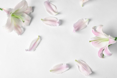 Photo of Flat lay composition with beautiful blooming lily flowers on white background