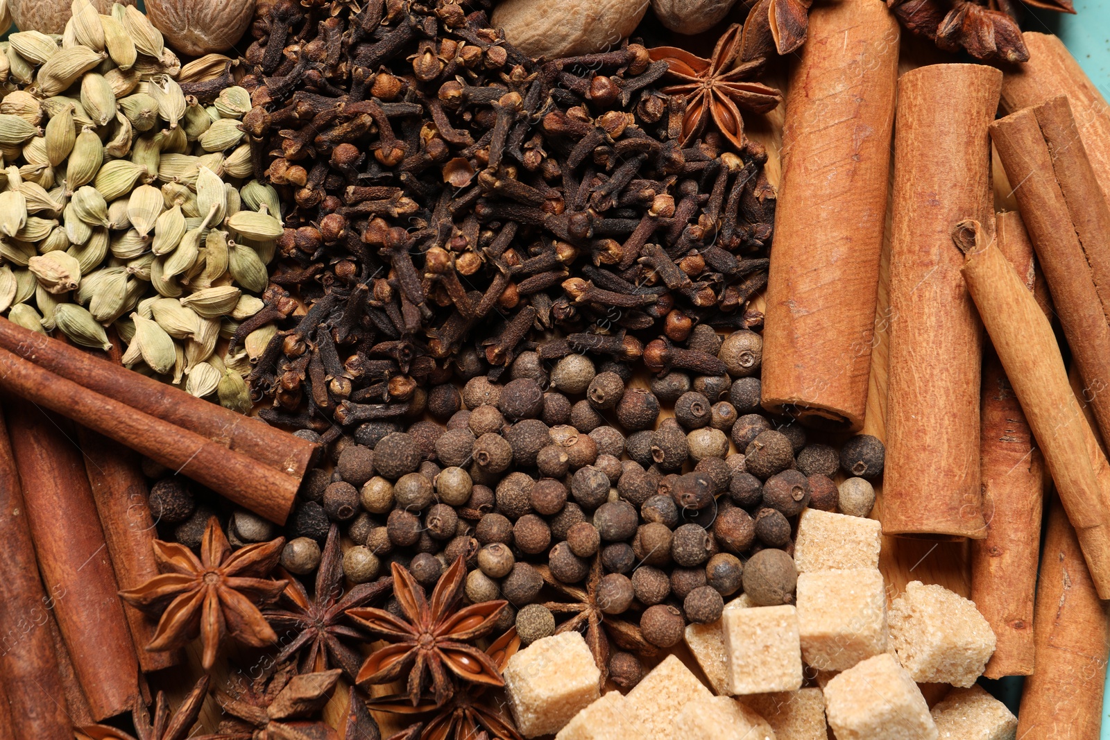 Photo of Different aromatic spices as background, top view