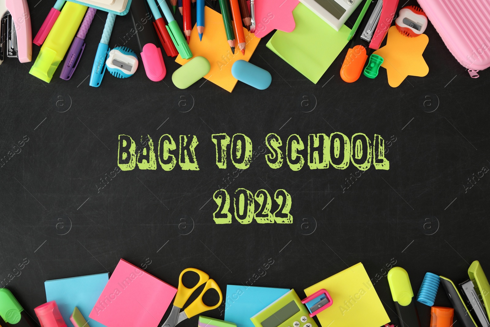 Image of Back to school 2022. Frame of different stationery on blackboard, flat lay