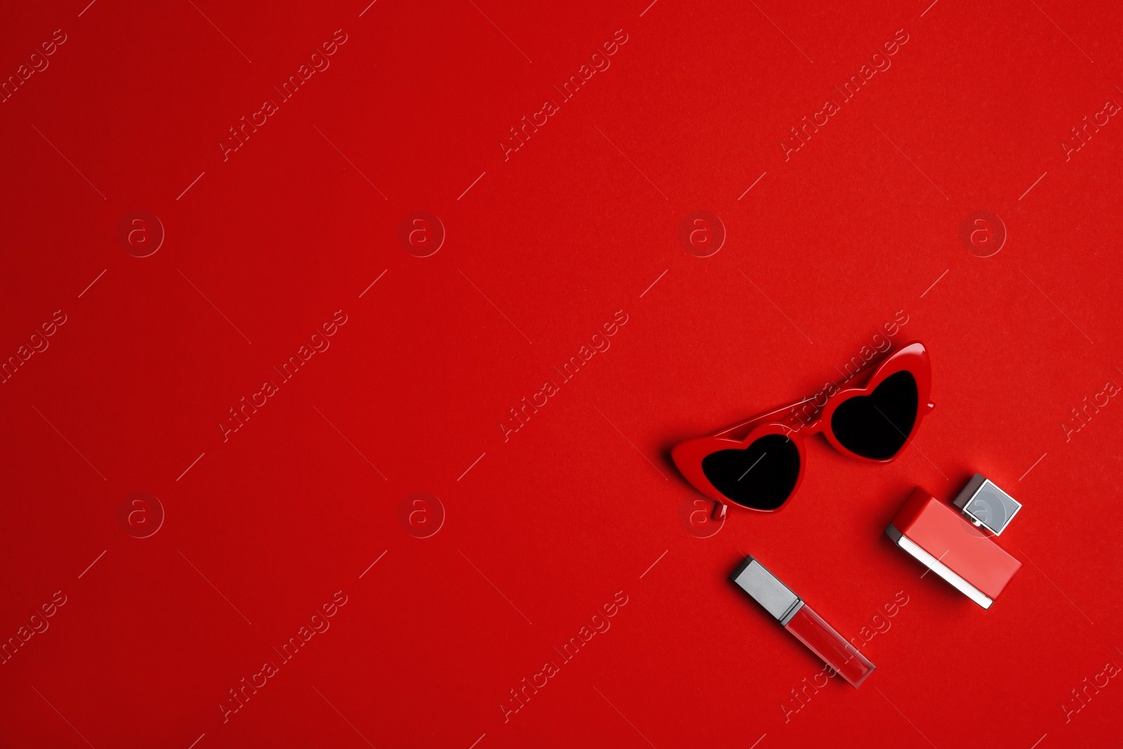 Photo of Flat lay composition with stylish women's sunglasses on red background. Space for text