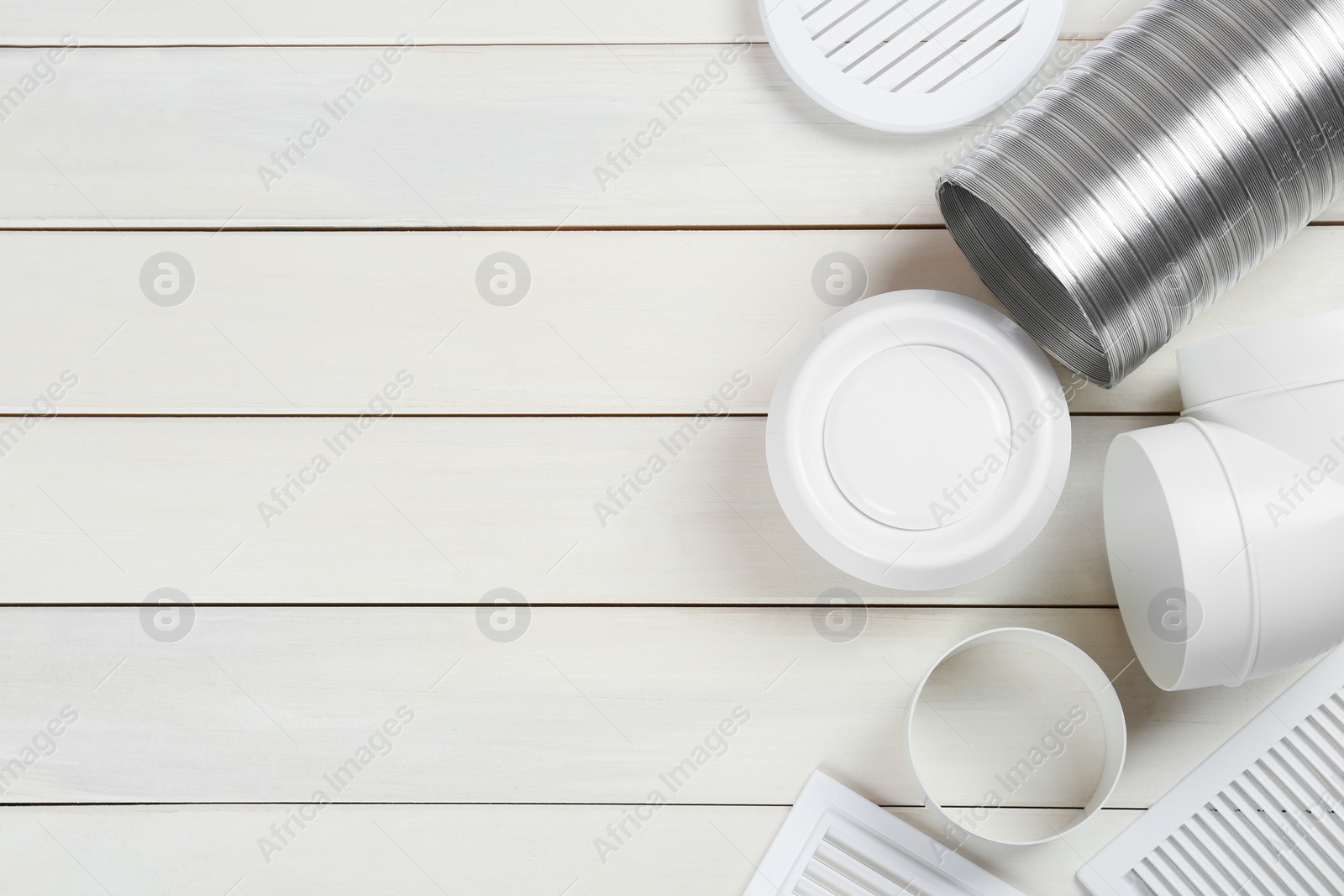 Photo of Parts of home ventilation system on white wooden surface, flat lay. Space for text