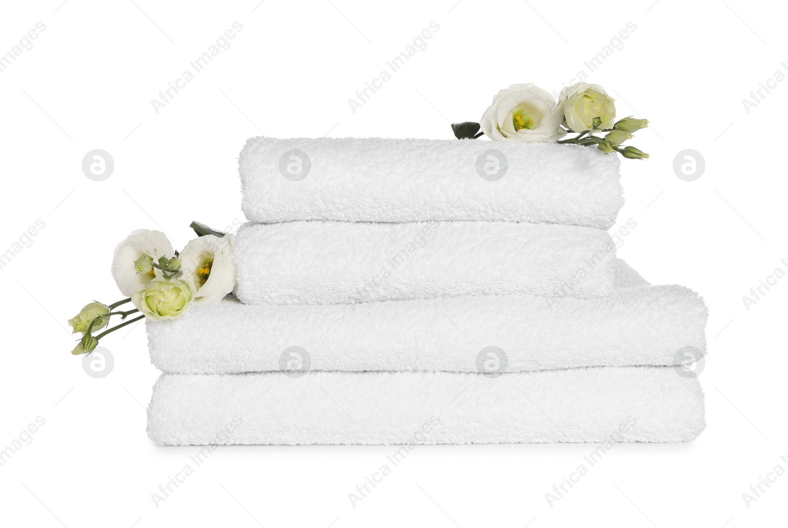 Photo of Stack of clean soft towels with flowers isolated on white