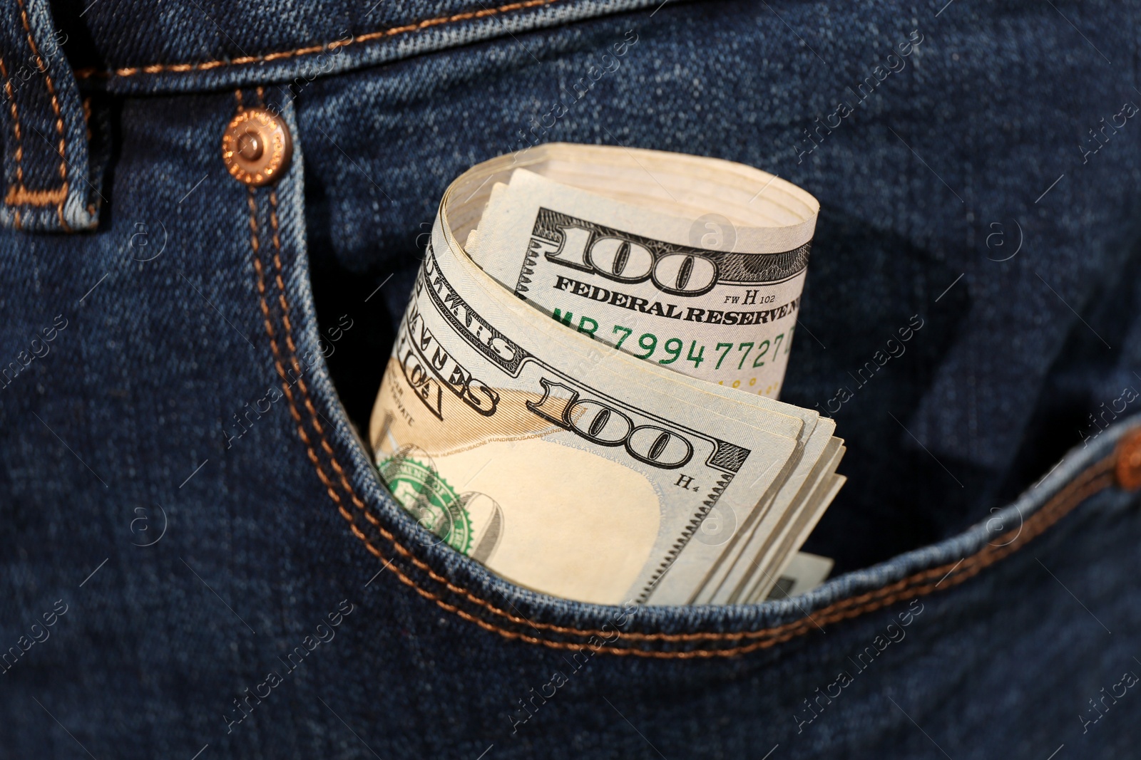 Photo of Dollar banknotes in pocket of jeans, closeup. Spending money