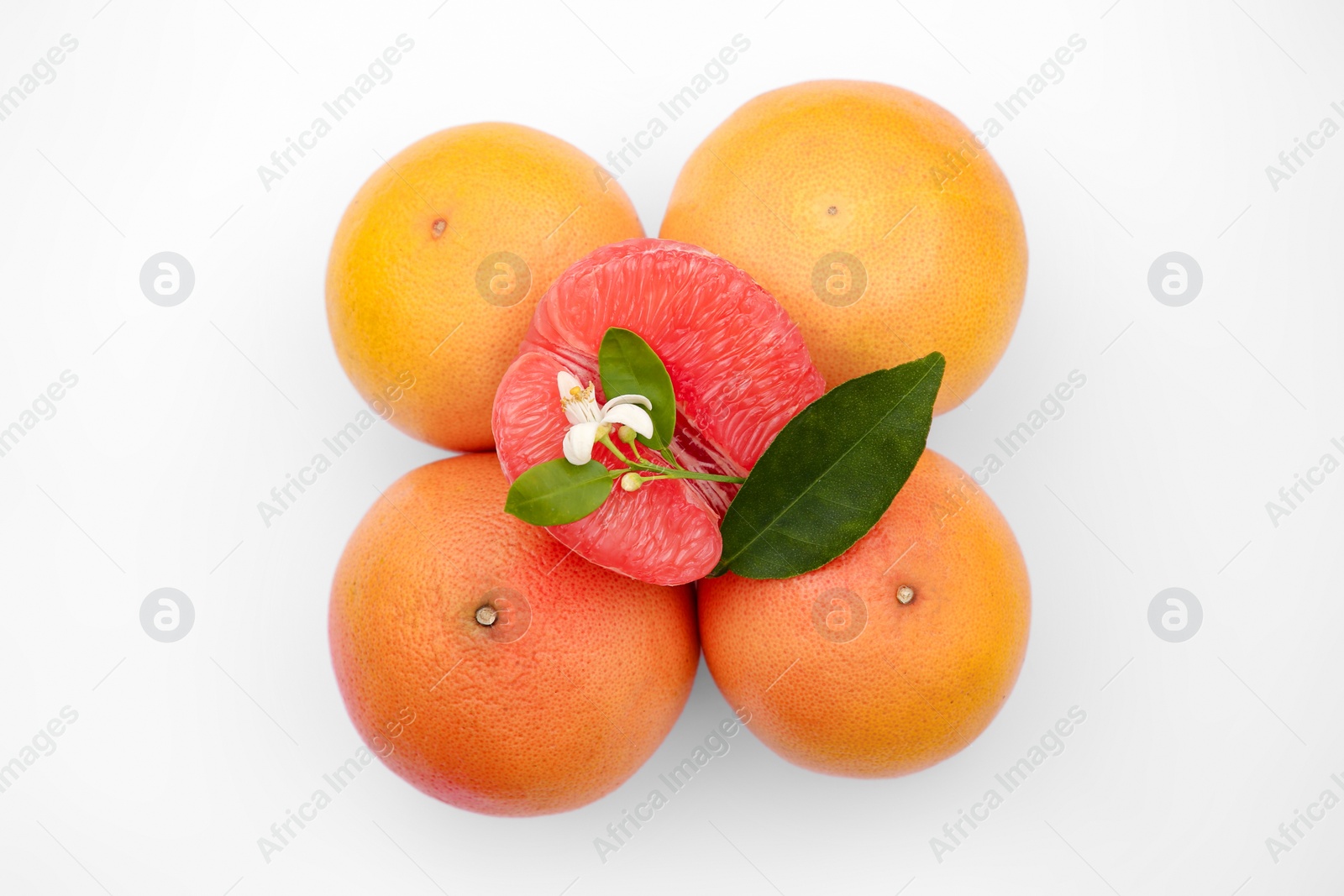 Photo of Fresh grapefruits and green leaves on white background, top view