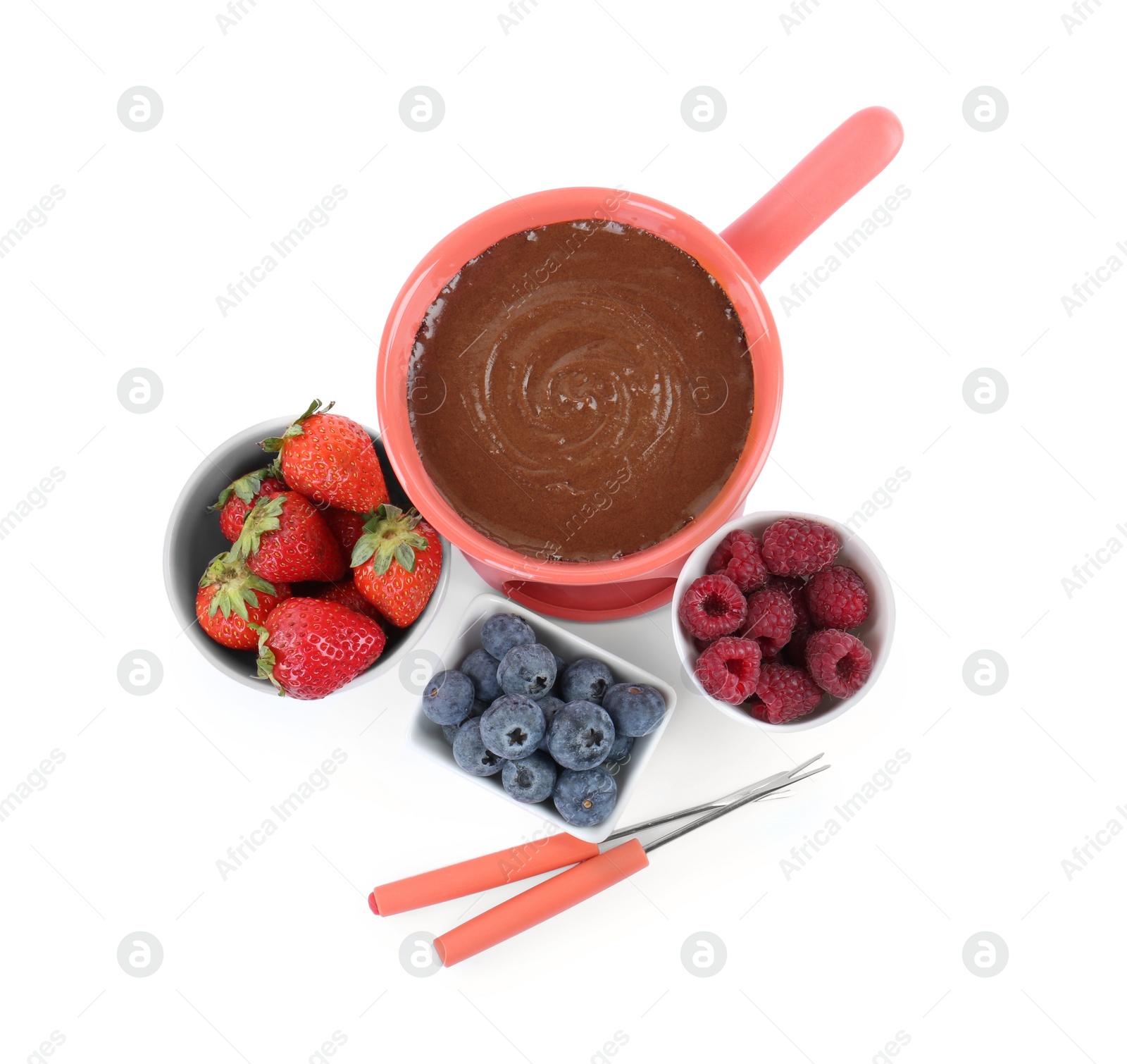 Photo of Fondue pot with melted chocolate, fresh berries and forks isolated on white, top view