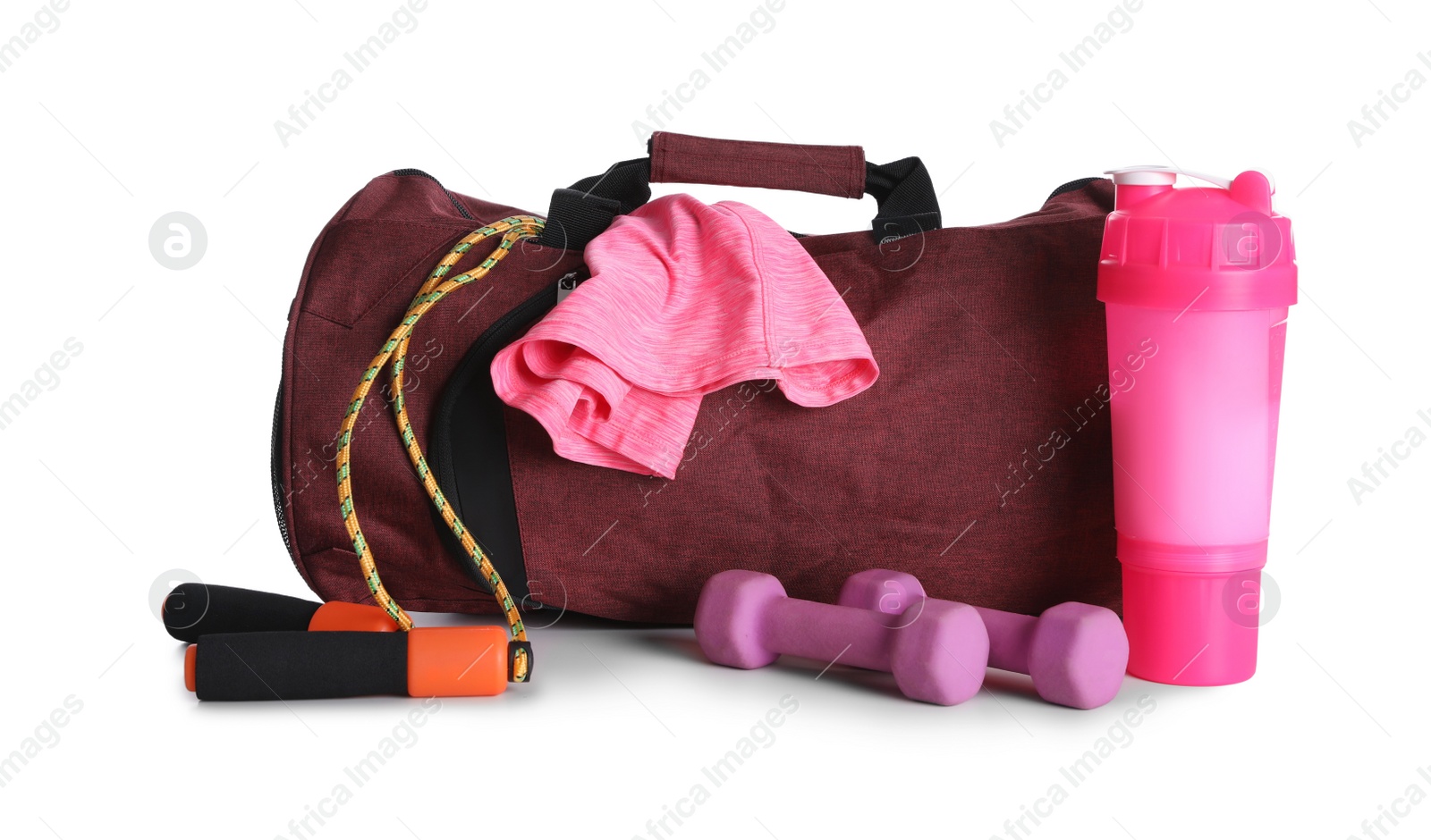 Photo of Sports bag and gym equipment on white background