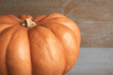 Photo of Fresh ripe pumpkin on wooden background, closeup