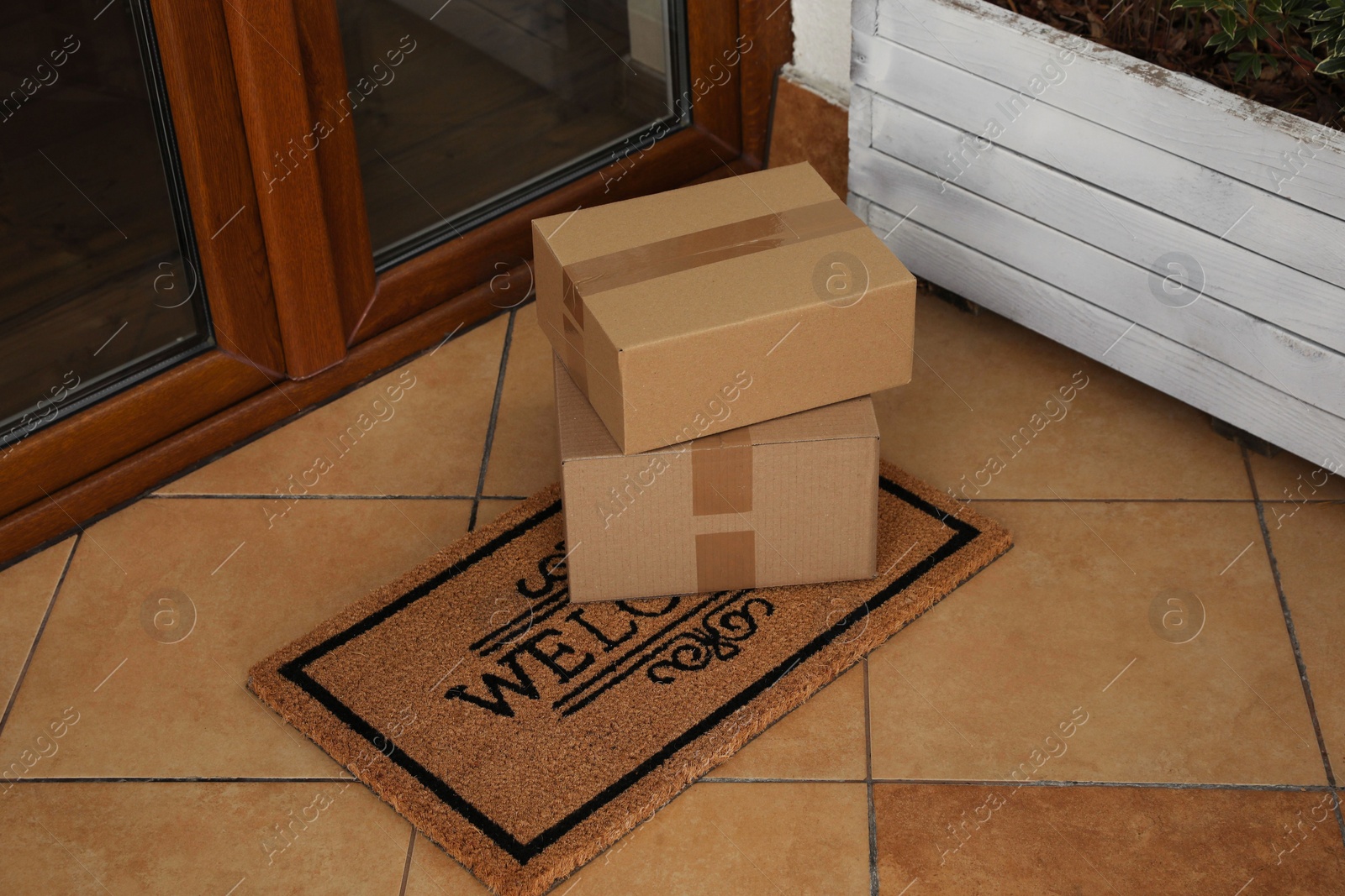 Photo of Parcels delivered on mat near front door