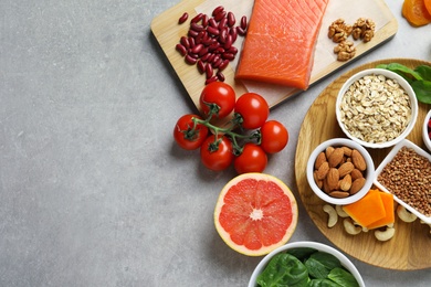 Photo of Assortment of heart-healthy products on grey background, flat lay. Space for text