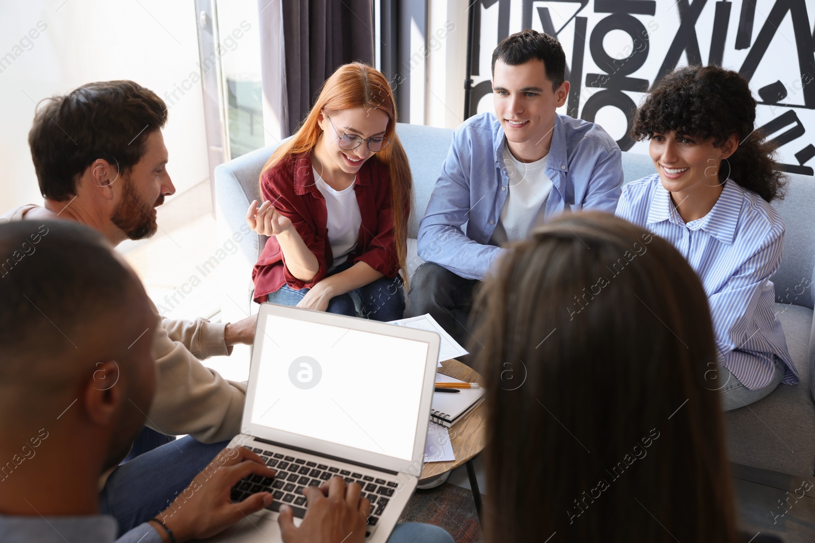 Photo of Team of employees working together in office. Startup project