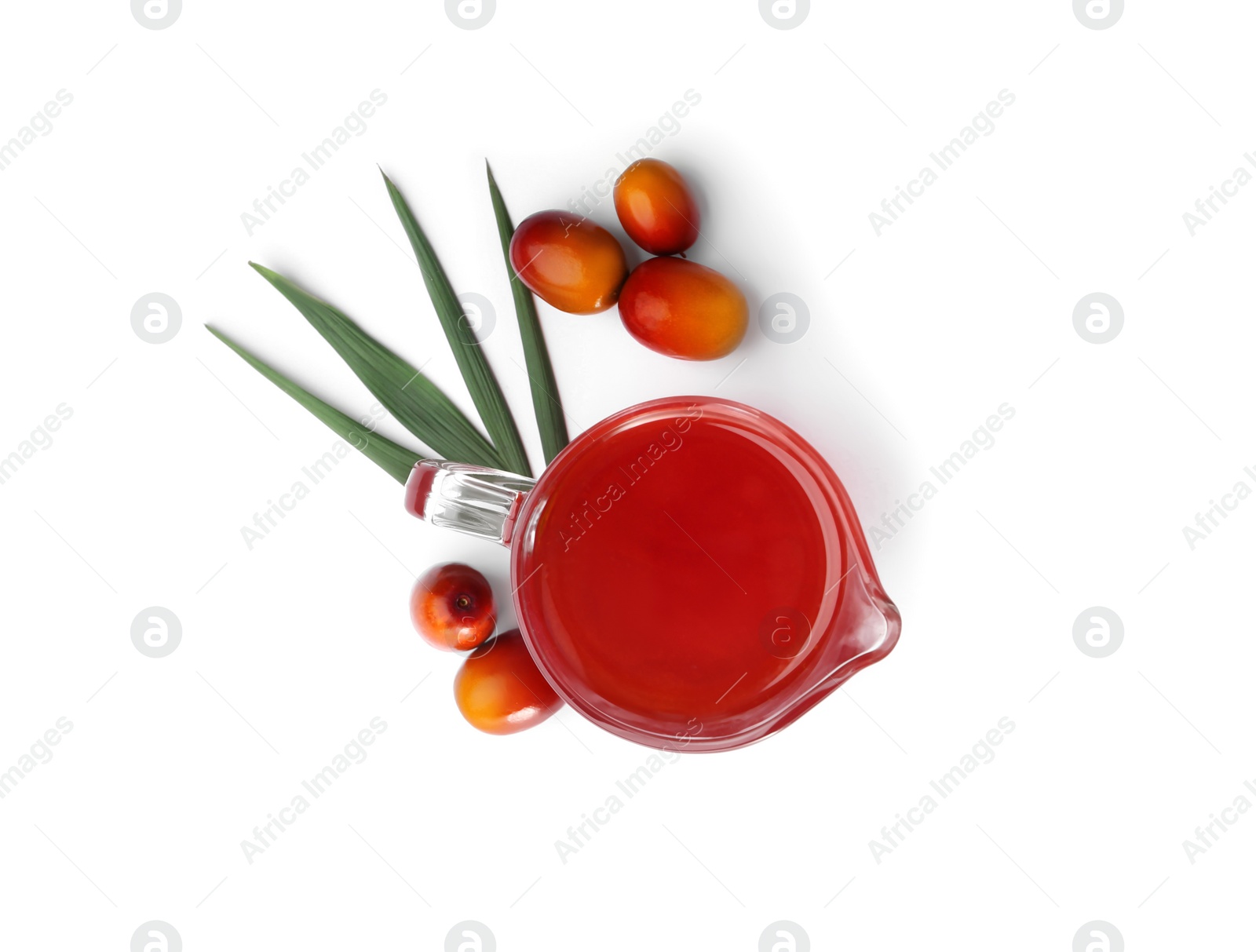 Photo of Palm oil in glass jug, tropical leaf and fruits isolated on white, top view