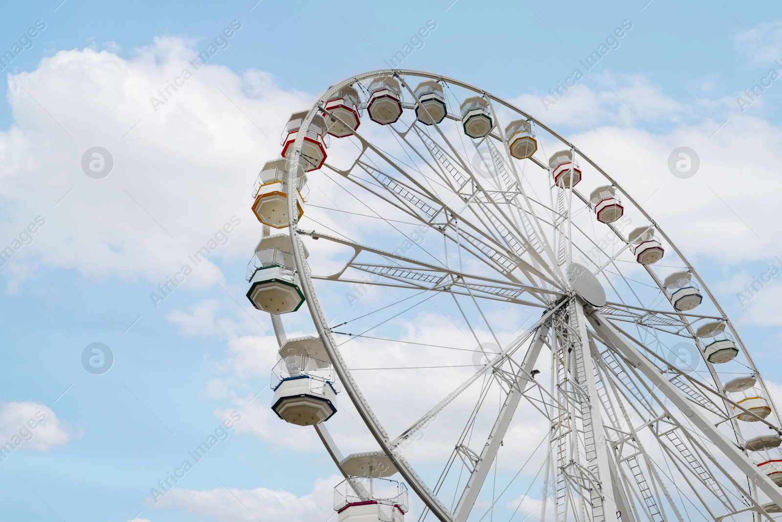 Photo of Large white observation wheel against sky, low angle view. Space for text