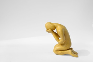 Photo of Plasticine figure of crying human on white background. Space for text