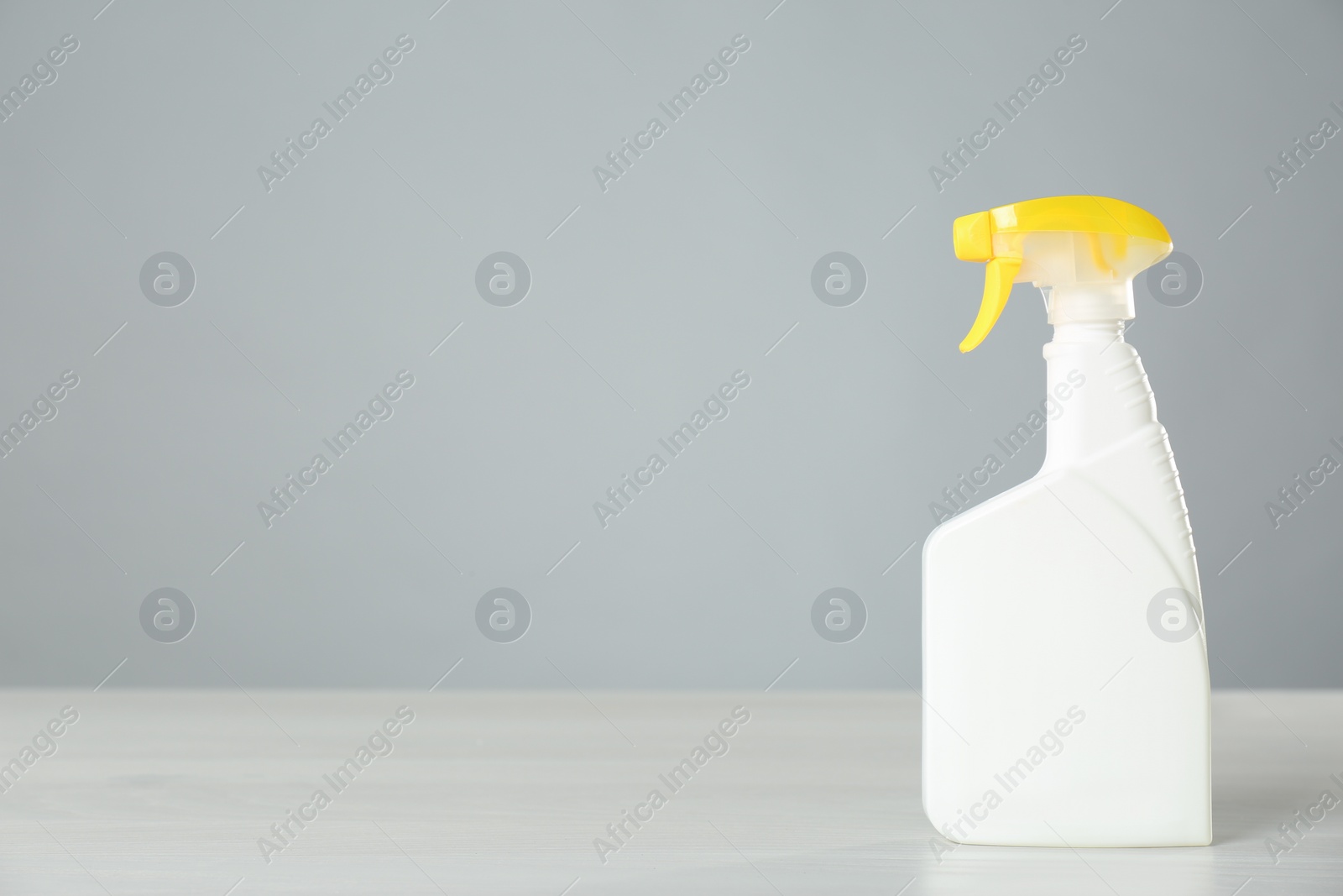 Photo of Bottle of cleaning product on light table. Space for text