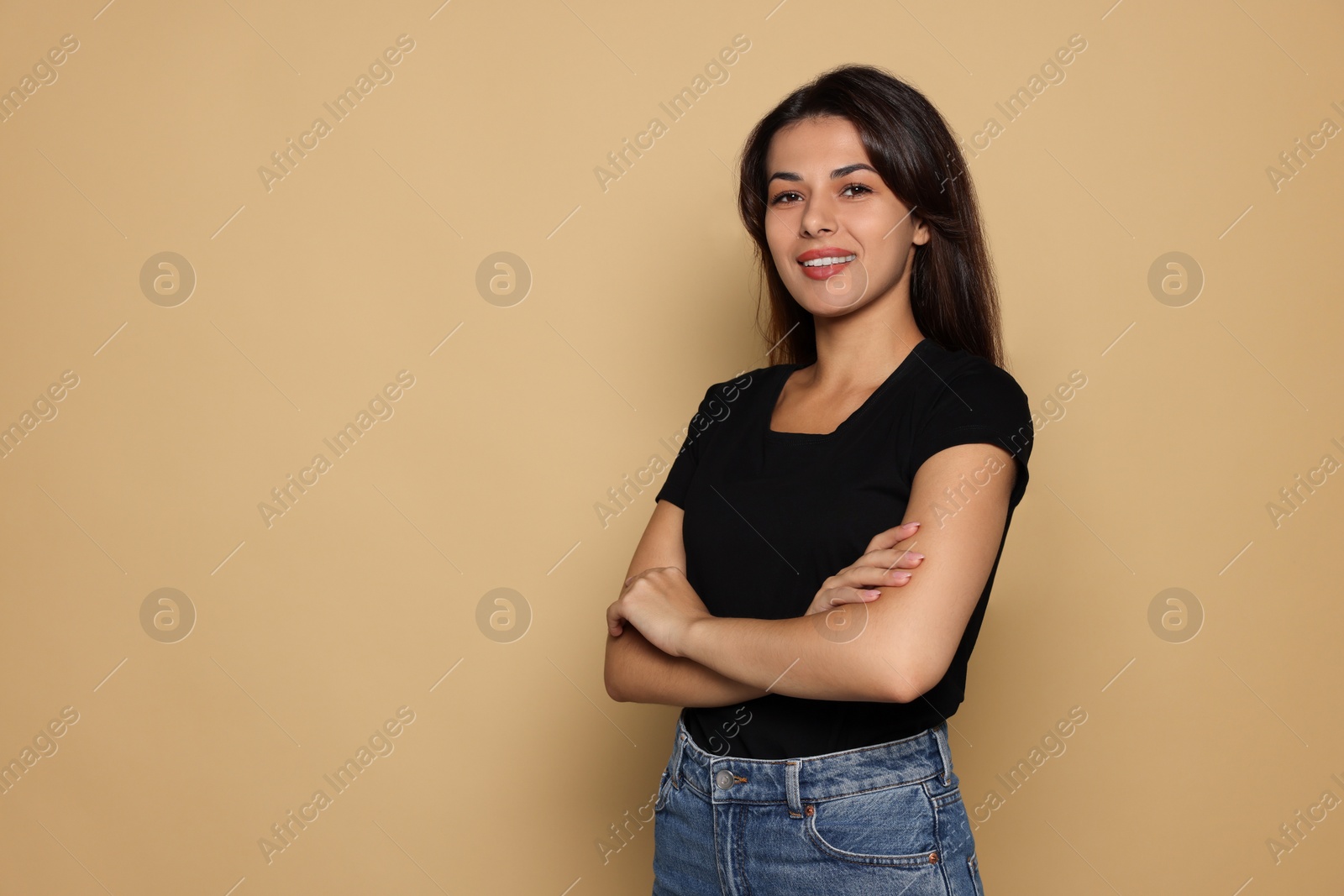 Photo of Portrait of beautiful young woman on pale orange background. Space for text