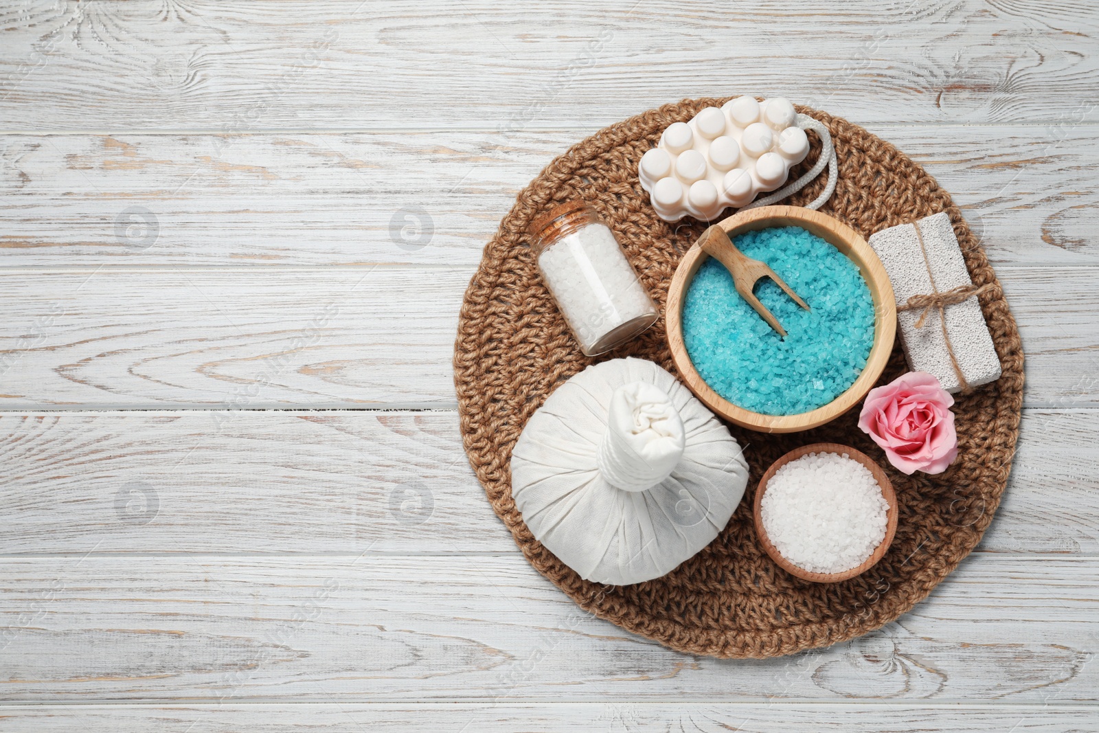 Photo of Composition of herbal bag and spa products on white wooden table, top view. Space for text