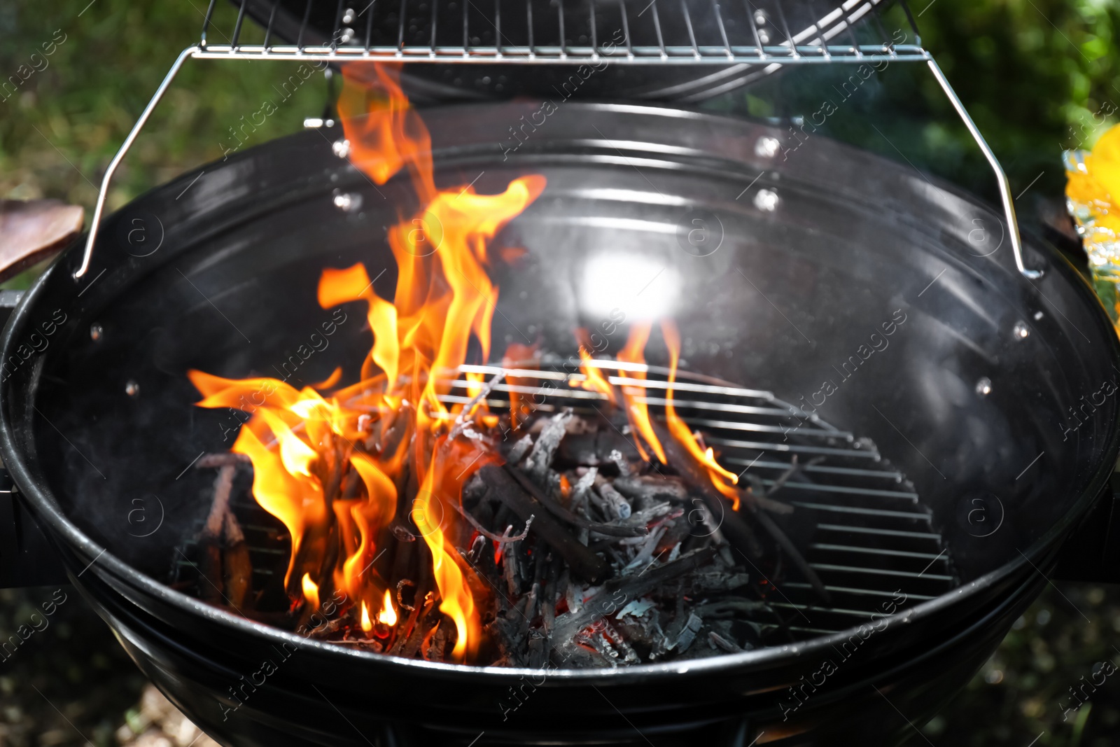 Photo of New modern barbecue grill with coals, closeup