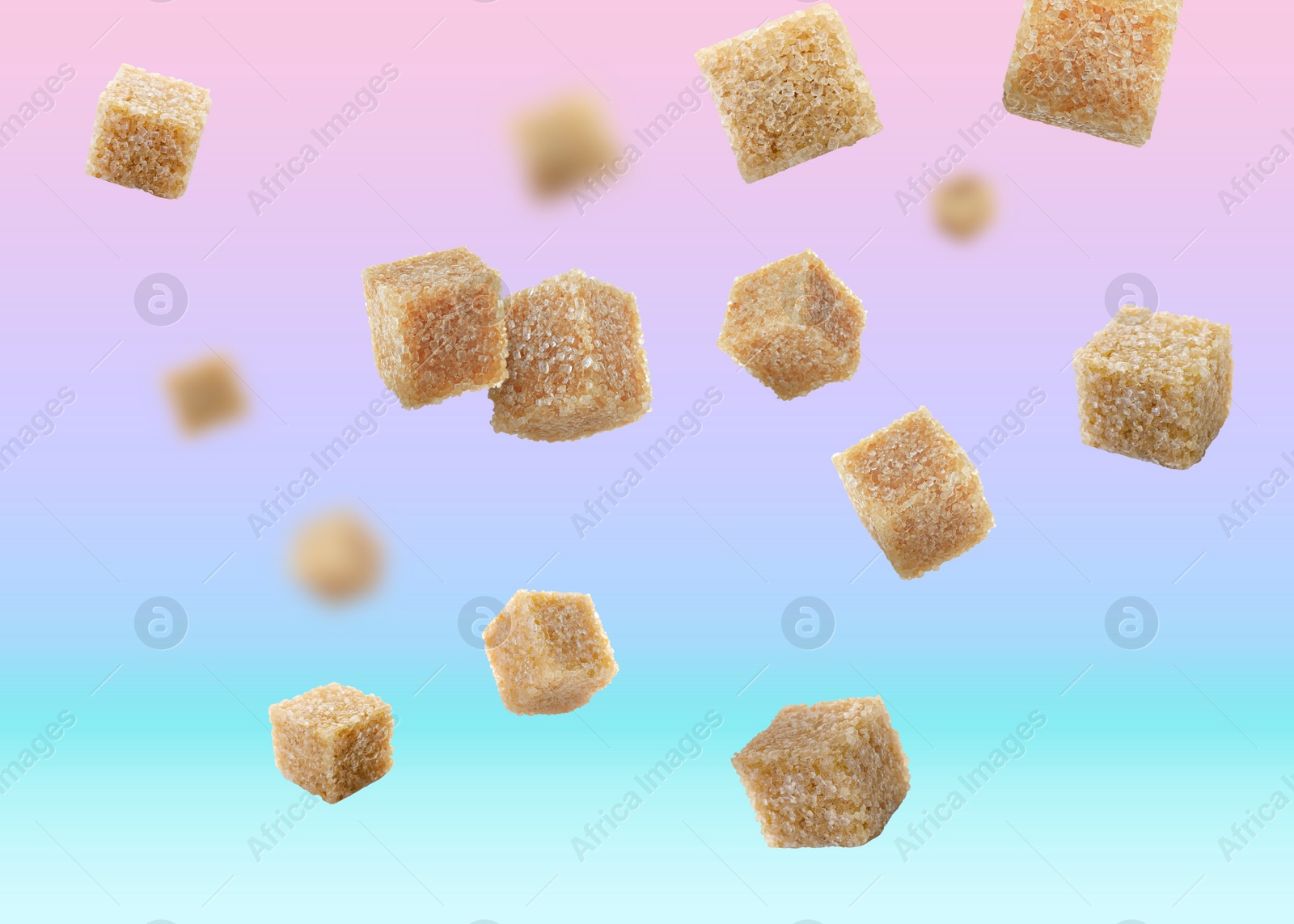 Image of Brown cane sugar cubes falling on color gradient background