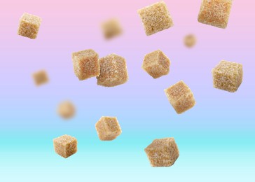 Image of Brown cane sugar cubes falling on color gradient background