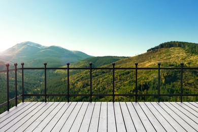 Outdoor wooden terrace revealing picturesque view on mountains in morning