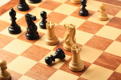 Wooden chessboard with game pieces as background