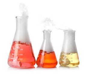 Laboratory flasks with colorful liquids and steam isolated on white. Chemical reaction