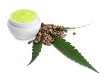 Photo of Jar with hemp cream, seeds and green leaf on white background. Natural cosmetics