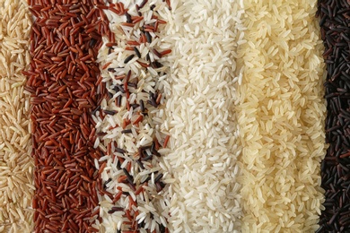 Brown and other types of rice as background, closeup