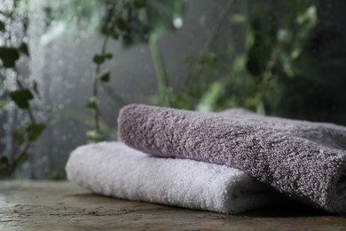 Photo of Two terry towels on table in bathroom